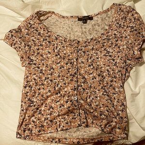I’m selling a crop top with buttons and floral pattern
